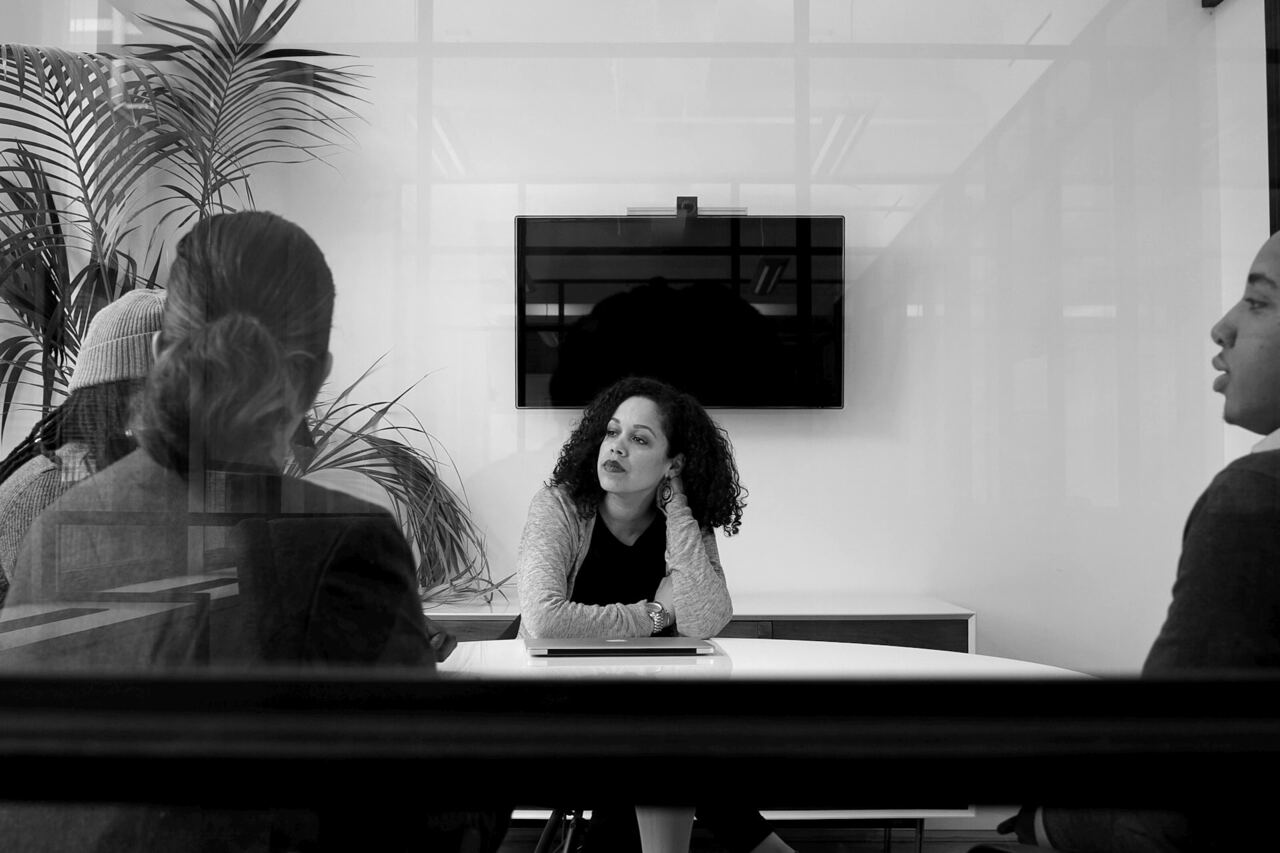 Colleagues in a working meeting in a glass-walled office